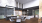 Resident lounge with soft seating, table and presentation kitchen.
