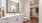 a bathroom with a large closet enterance,  vanity and large miror