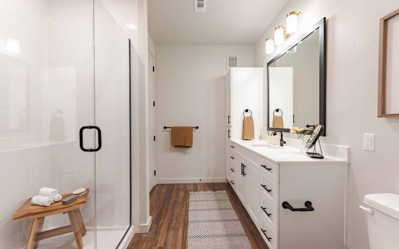 bathroom with large mirror sink and toilet