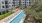 A pool with tanning deck and chairs