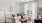 A room with a ceiling fan, seating, and tv stand